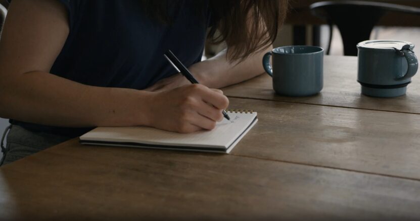 woman writing in notebook